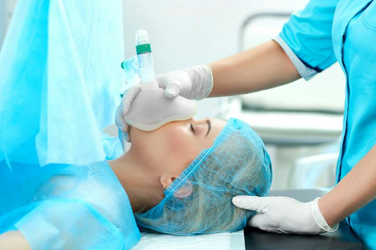 Cropped shot of a nurse holding oxygen mask for a female patient during surgery healthcare living profession help assistance health operation medicine clinic treatment concept.